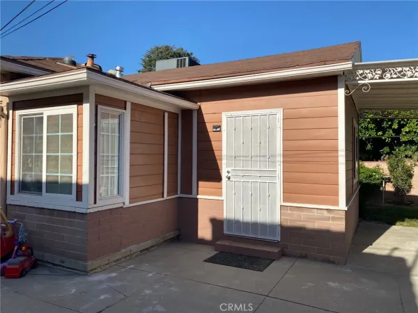 a view of an empty room with a fireplace and a window