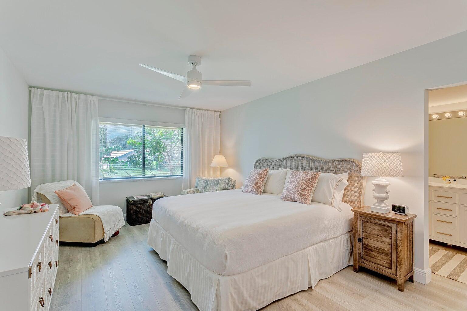 17053 Waterbend Drive, Unit 231 Jupiter, FL 33477 - Photo 15 of 26 a spacious bedroom with a bed and a couch