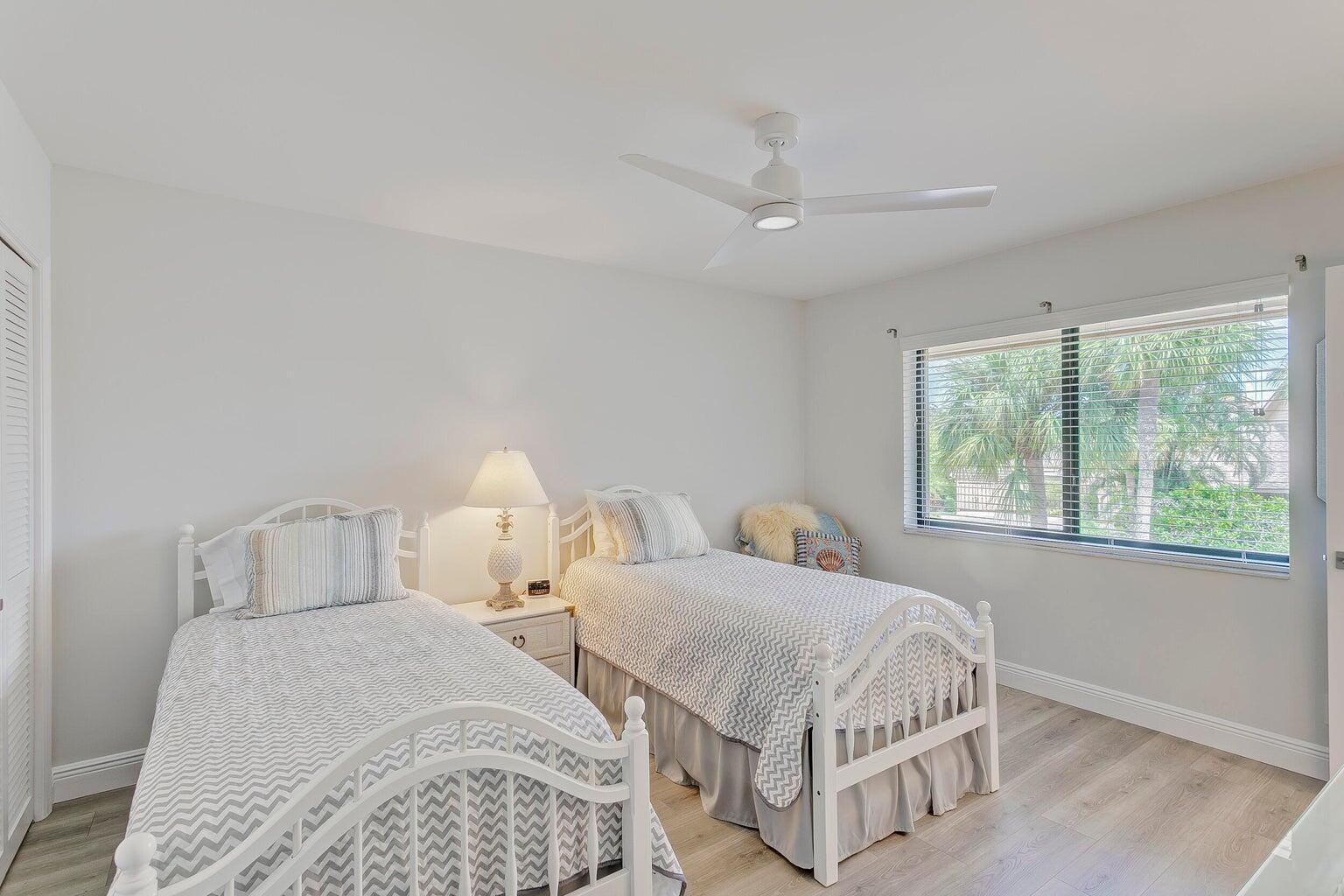 17053 Waterbend Drive, Unit 231 Jupiter, FL 33477 - Photo 19 of 26 a bedroom with two beds and a window