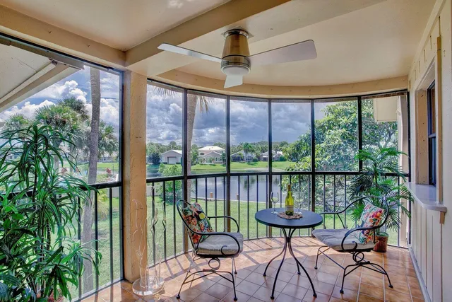 a view of a balcony with furniture and a potted plant