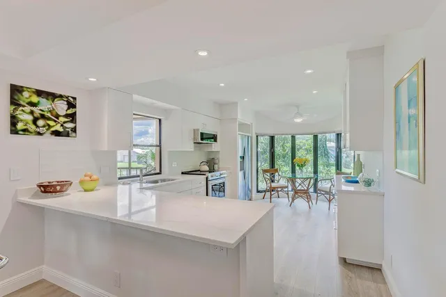 a kitchen with a table chairs and a view of living room