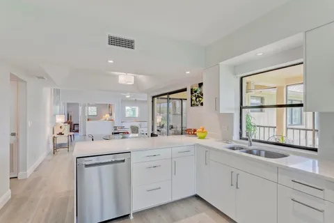 a kitchen with sink attached with living room