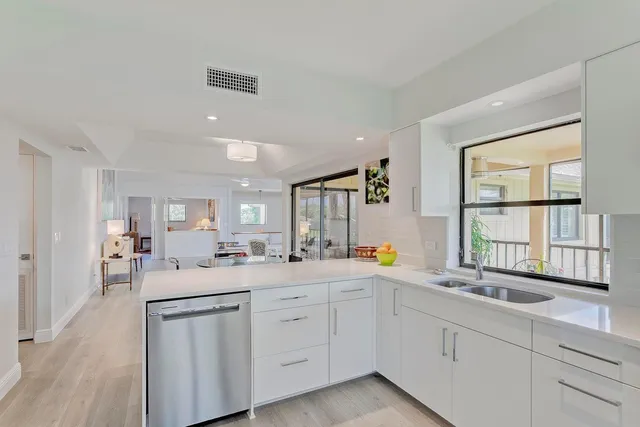 a kitchen with sink attached with living room