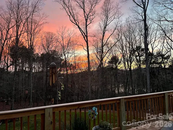 a view of a wooden fence and trees