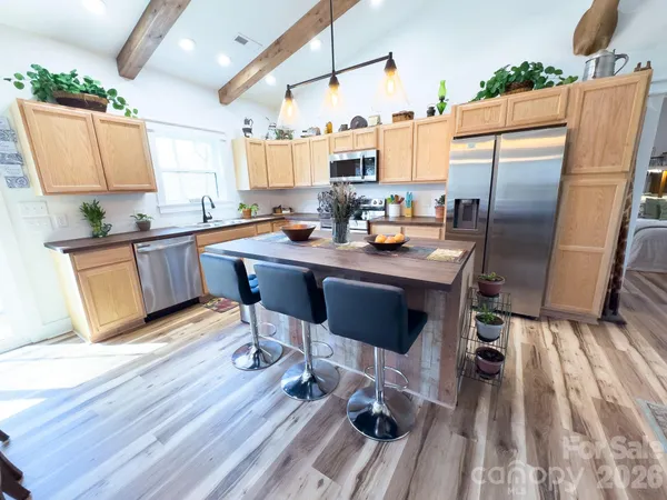 a kitchen with sink stove and chairs