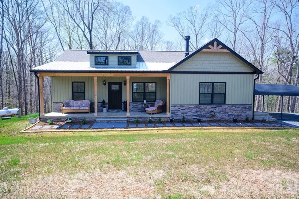 a front view of house with yard and outdoor seating