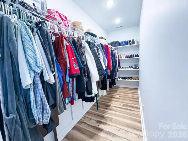 a bedroom with a bed and a chair