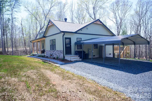 a view of a house with backyard and sitting area