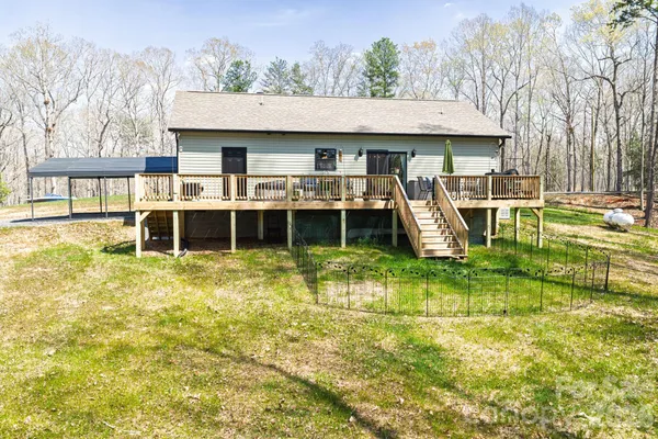 a view of a house with a yard balcony and sitting area