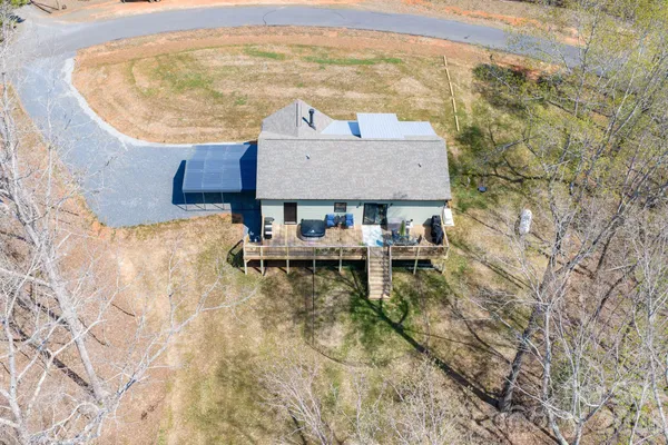 a aerial view of a house with table and chairs