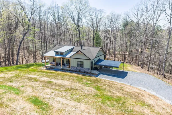 a view of a house with swimming pool and sitting area
