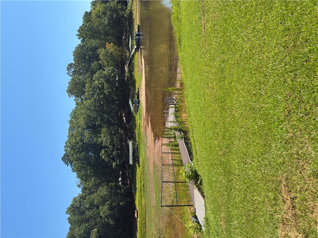 125 Ricks Road Fair Play, SC 29643 - Photo 20 of 23 A wooden gangway leads down to the quiet water's edge bordered by mature green trees.