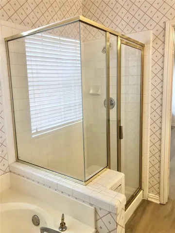 a bathroom with a bathtub and shower