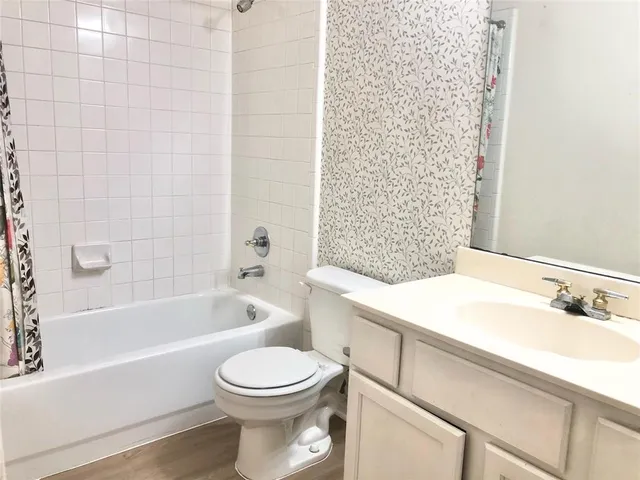 a bathroom with a sink a toilet and a bathtub