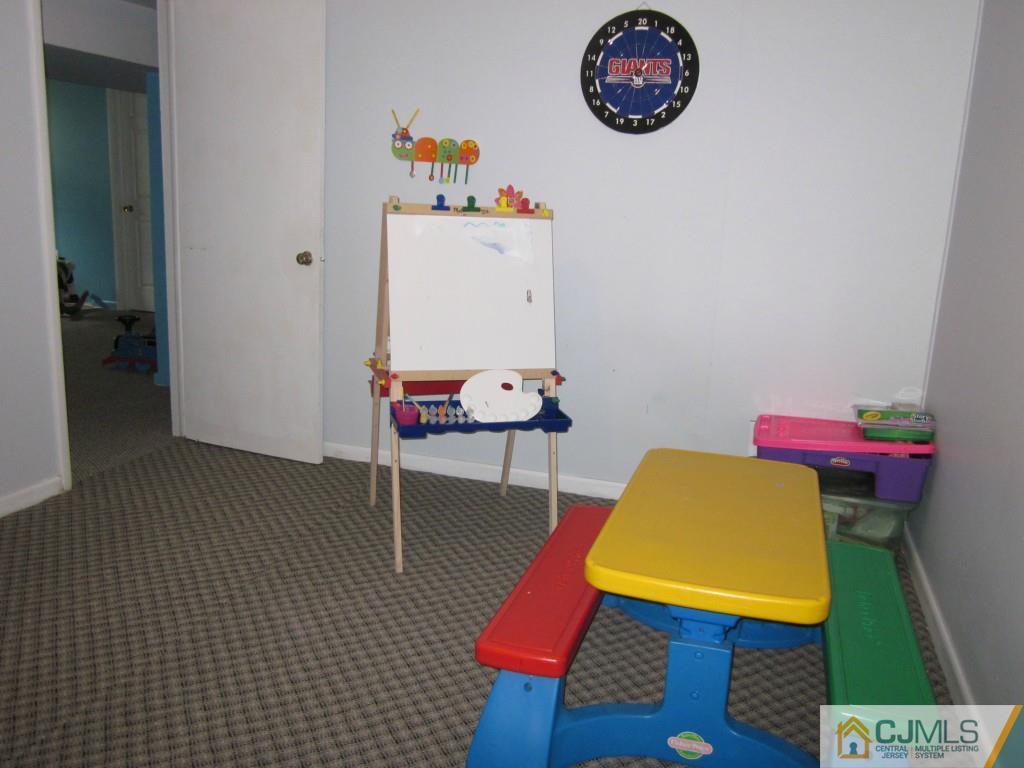 11 Ferris Road Edison, NJ 08817 - Photo 11 of 13 a room with furniture and a table