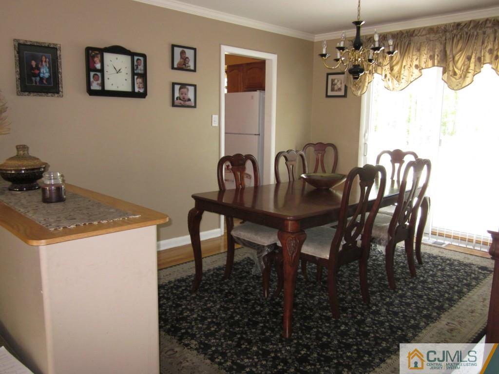 11 Ferris Road Edison, NJ 08817 - Photo 3 of 13 a view of a dining room with furniture and chandelier