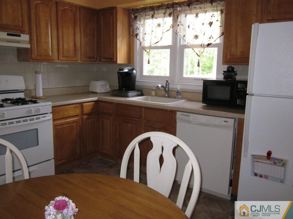 11 Ferris Road Edison, NJ 08817 - Photo 5 of 13 a kitchen with a stove a sink and a microwave