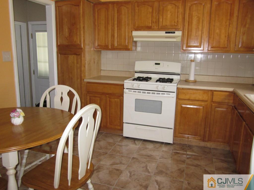11 Ferris Road Edison, NJ 08817 - Photo 6 of 13 a kitchen with a stove a sink and a microwave