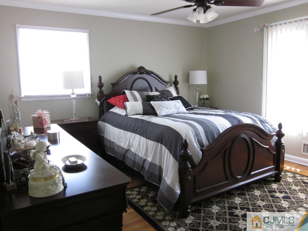 11 Ferris Road Edison, NJ 08817 - Photo 7 of 13 a bedroom with a bed and a chandelier