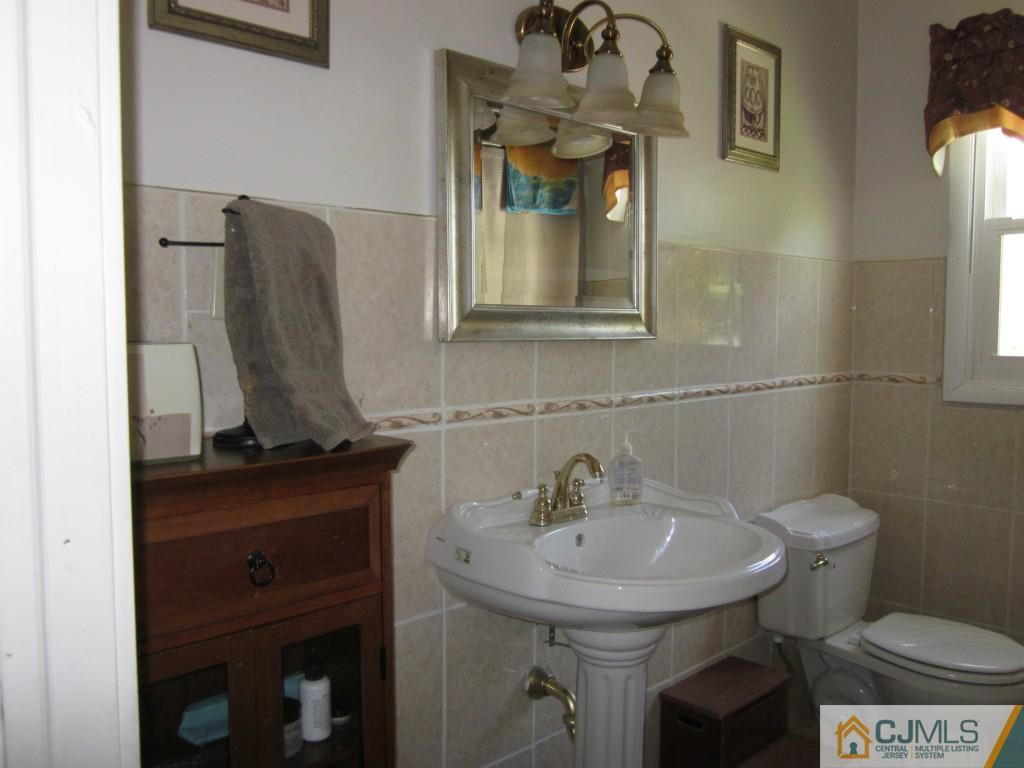 11 Ferris Road Edison, NJ 08817 - Photo 9 of 13 a bathroom with a sink a toilet and mirror