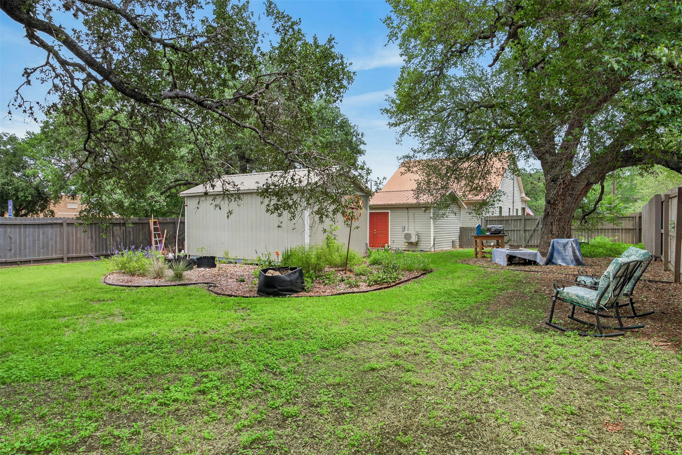 217 Walnut Avenue Luling, TX 78648 - Photo 34 of 38 a view of a house with backyard sitting area and garden
