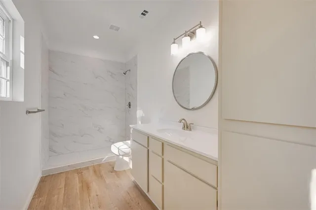 a bathroom with a sink a toilet and a mirror