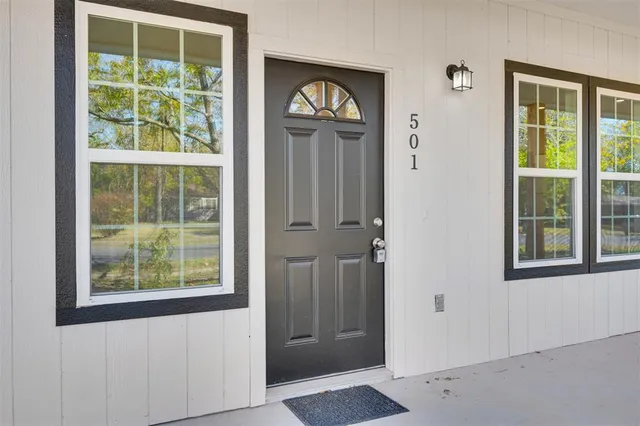 an empty room with windows and closet