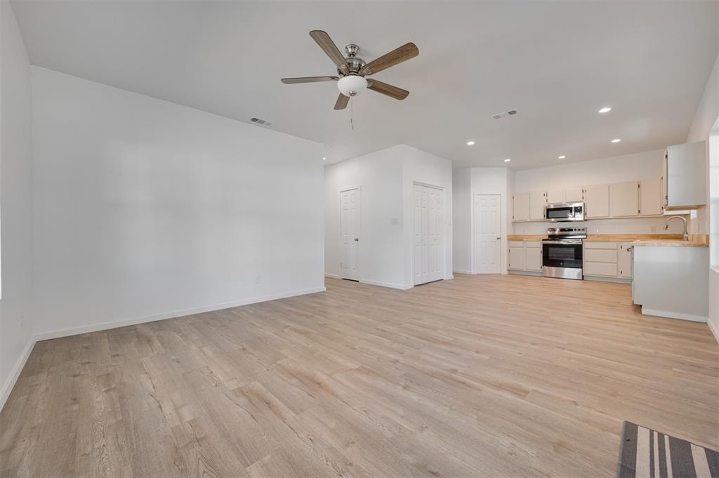 501 Southeast 1st Street Cooper, TX 75432 - Photo 6 of 29 a view of an empty room with a kitchen