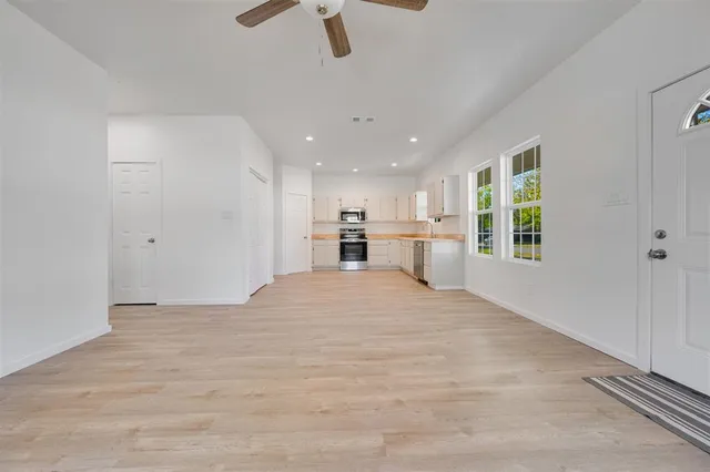 a view of a kitchen with a sink and a window