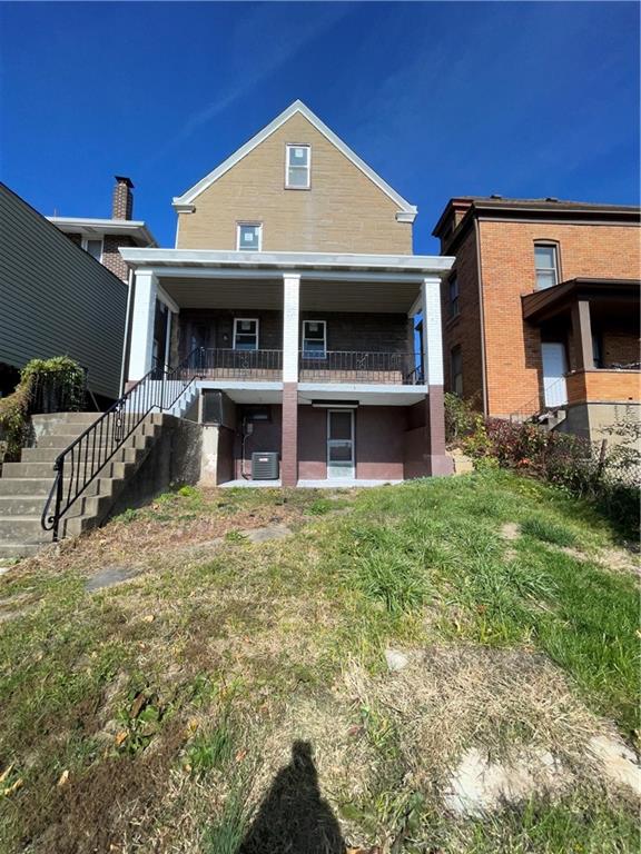 11 Frazier Avenue McKees Rocks, PA 15136 - Photo 3 of 22 a view of a house with a small yard and a car parked in it