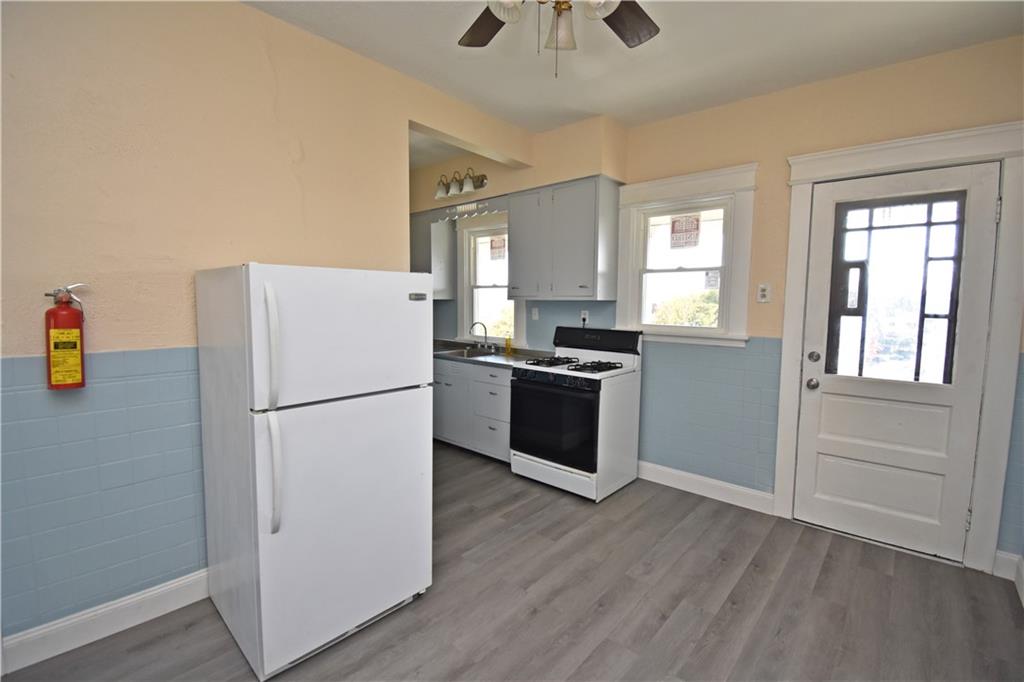 11 Frazier Avenue McKees Rocks, PA 15136 - Photo 10 of 22 a white refrigerator freezer and a stove sitting inside of a kitchen