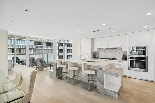 a kitchen with a table chairs refrigerator and cabinets
