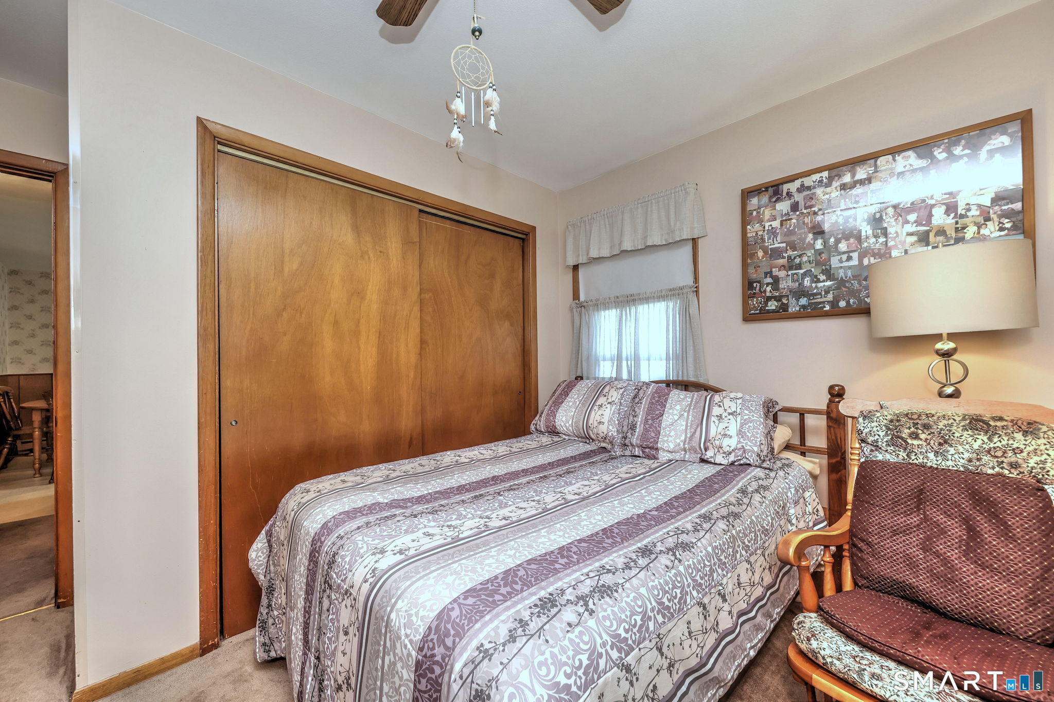 212 Swain Avenue Meriden, CT 06450 - Photo 27 of 38 a bedroom with a bed painting on wall and a large window