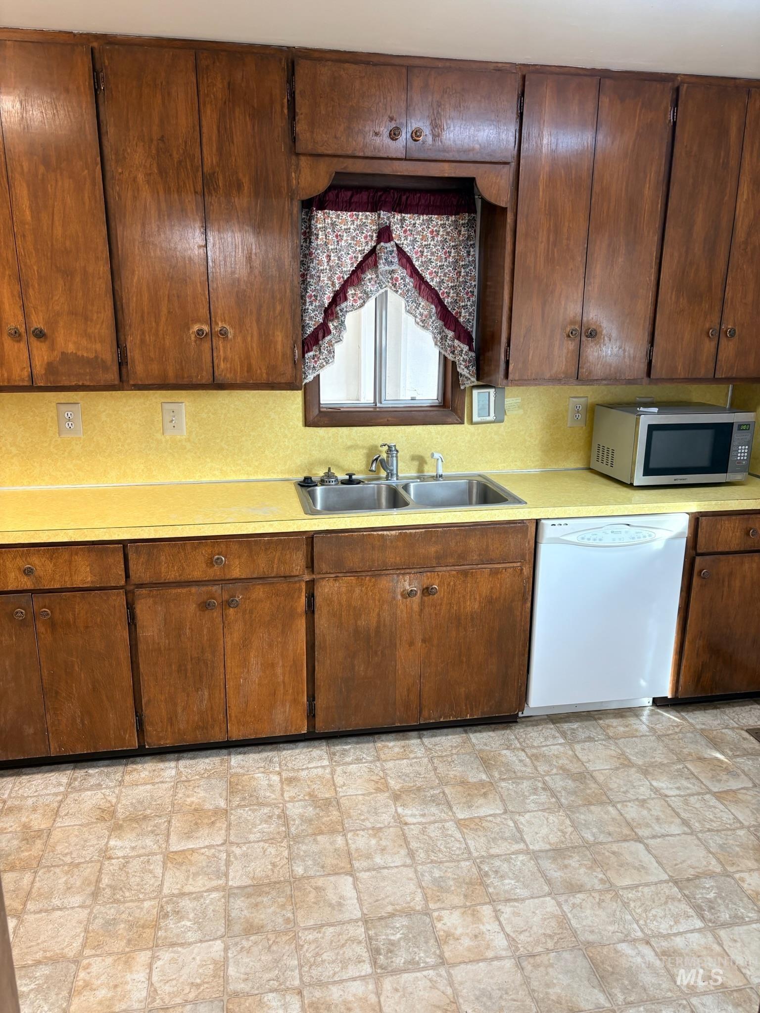 627 Southwest 3rd Street Fruitland, ID 83619 - Photo 13 of 35 Kitchen with light countertops, white dishwasher, and stainless steel microwave