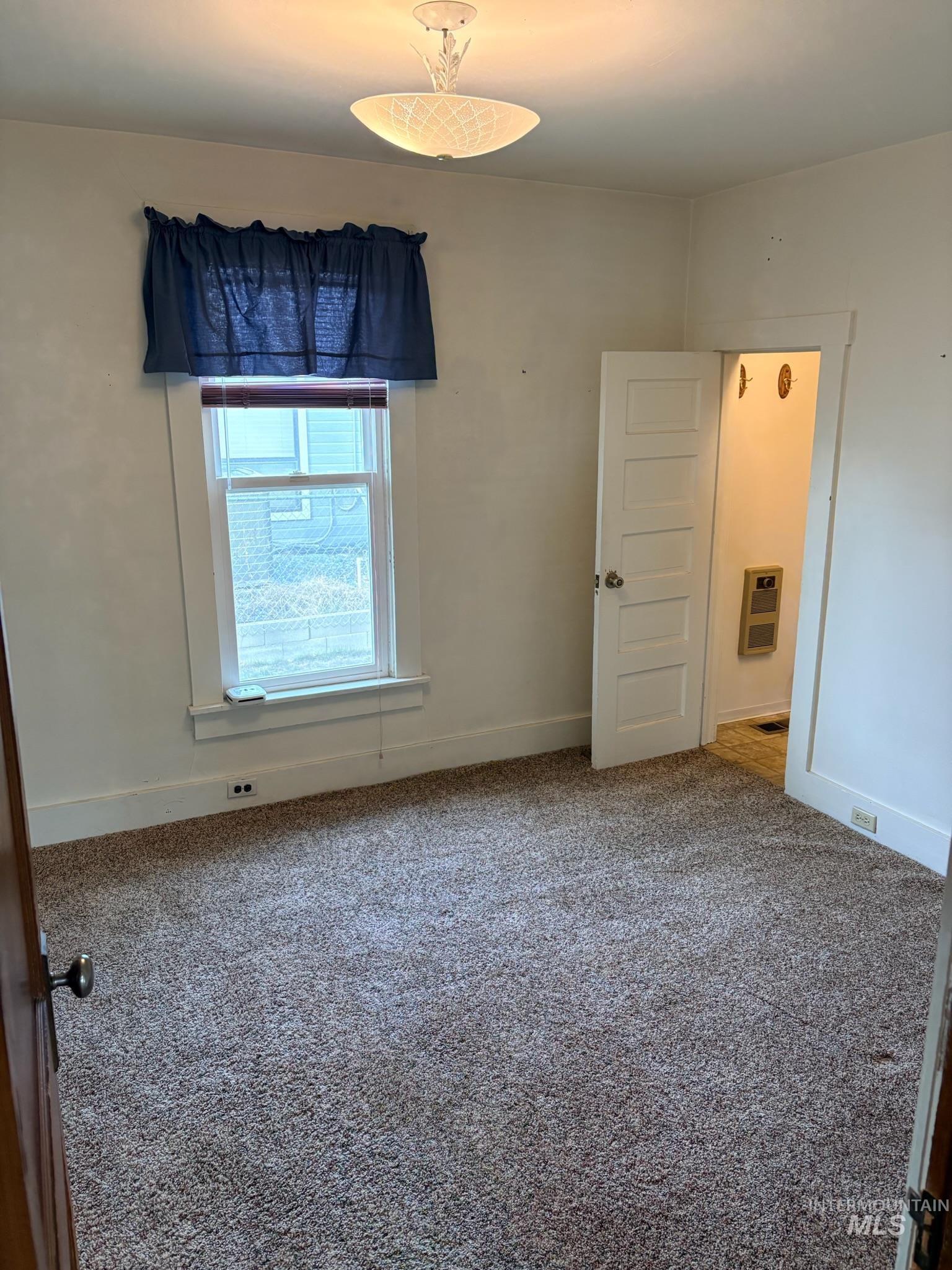 627 Southwest 3rd Street Fruitland, ID 83619 - Photo 16 of 35 Unfurnished room with carpet and heating unit