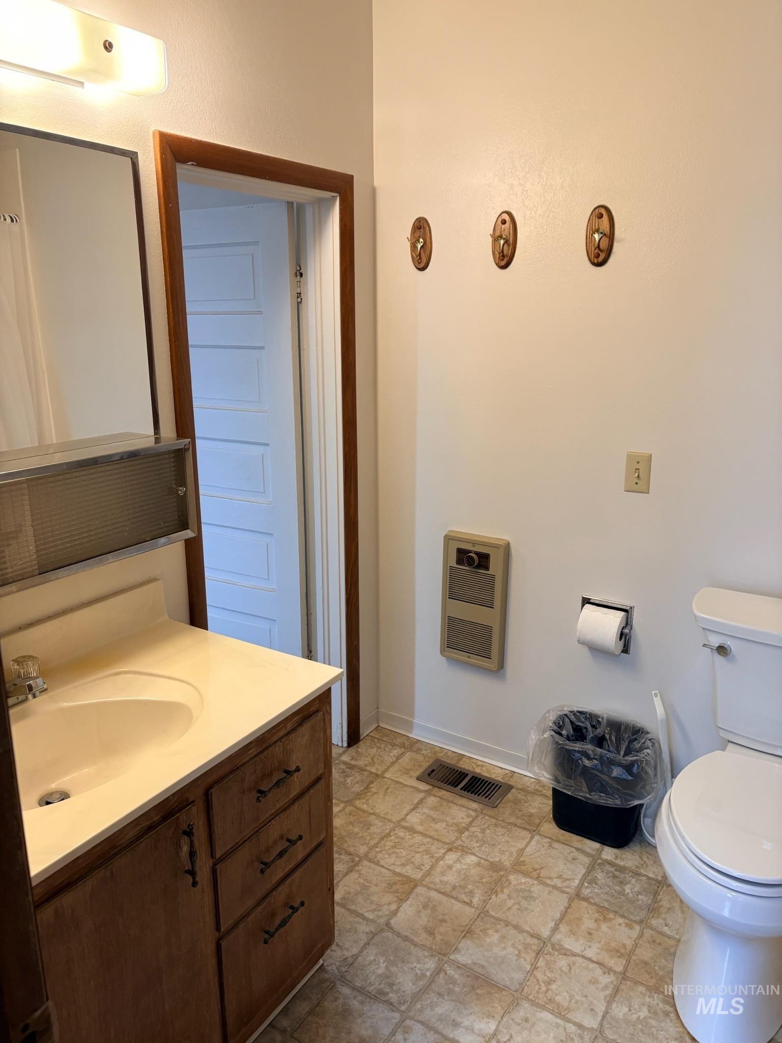 627 Southwest 3rd Street Fruitland, ID 83619 - Photo 21 of 35 Bathroom featuring vanity, heating unit, and stone finish flooring
