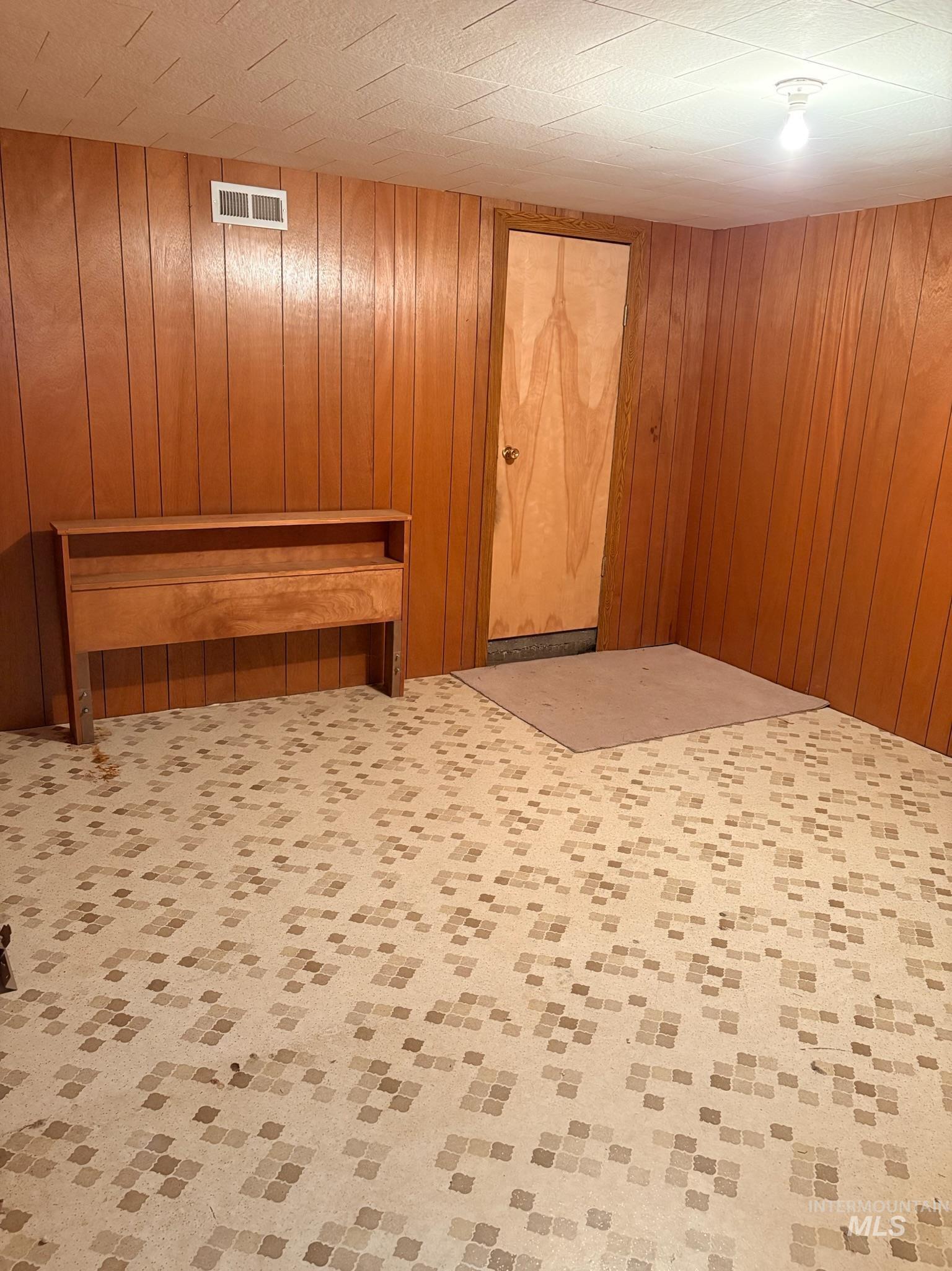 627 Southwest 3rd Street Fruitland, ID 83619 - Photo 30 of 35 Below grade area with carpet flooring and wood walls