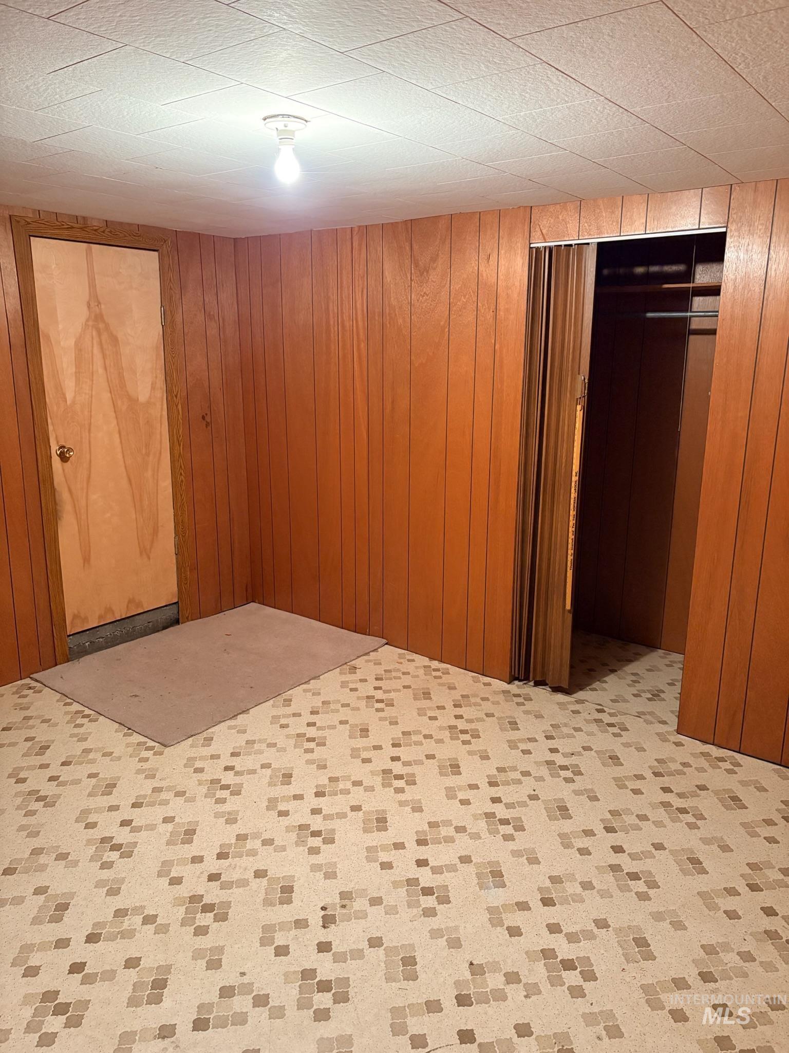 627 Southwest 3rd Street Fruitland, ID 83619 - Photo 31 of 35 Unfurnished room featuring light colored carpet and wood walls