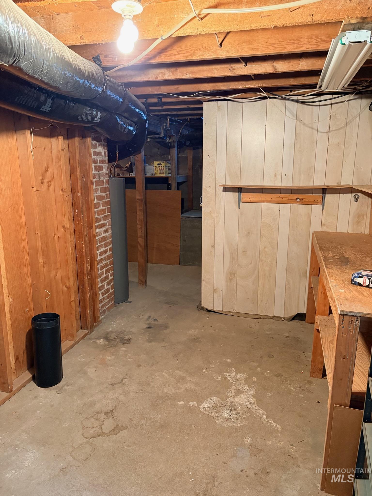 627 Southwest 3rd Street Fruitland, ID 83619 - Photo 32 of 35 Unfinished below grade area featuring wood walls and water heater