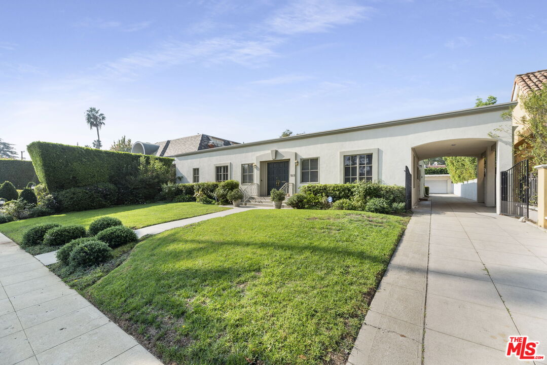 513 Foothill Road Beverly Hills, CA 90210 - Photo 2 of 9 a view of an house with backyard space and garden