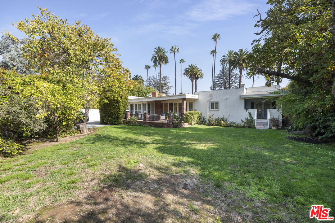 513 Foothill Road Beverly Hills, CA 90210 - Photo 7 of 9 a view of a house with a big yard and large trees