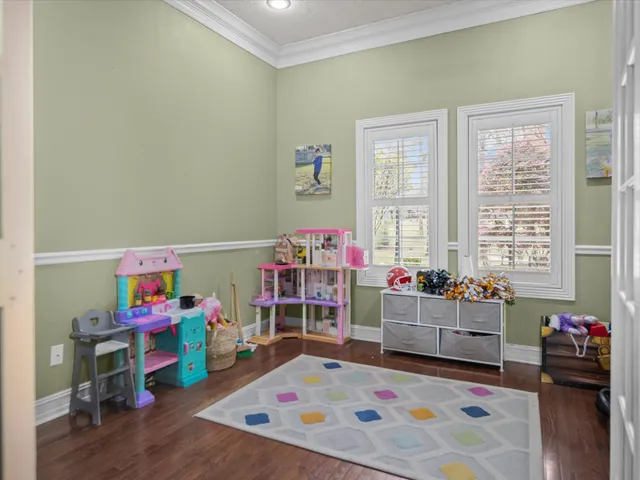 a children room with toys and a wooden floor