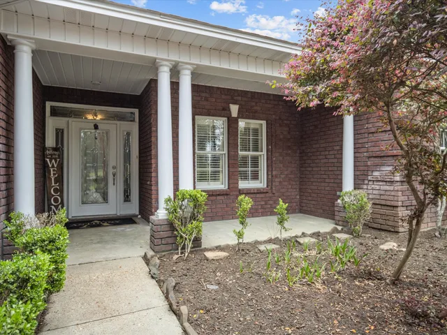 a front view of a house with garden
