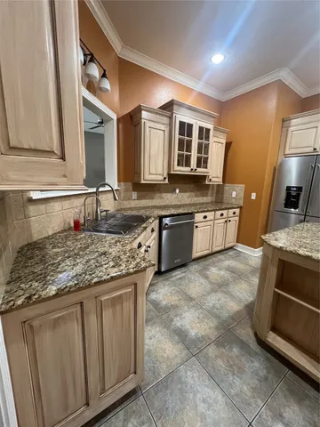 a kitchen with stainless steel appliances granite countertop a sink stove and oven