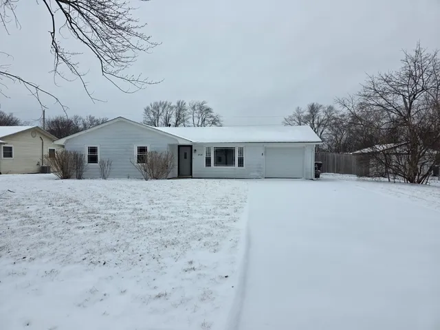a view of a house with a snow in the yard