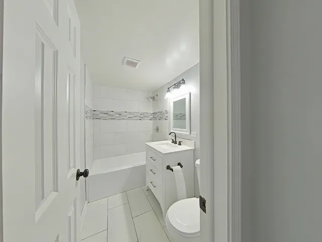 a bathroom with a toilet a sink and bathtub