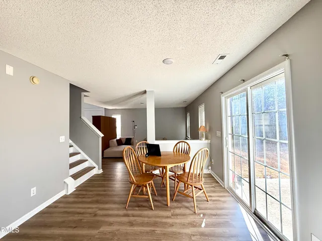 a dining room with furniture and wooden floor