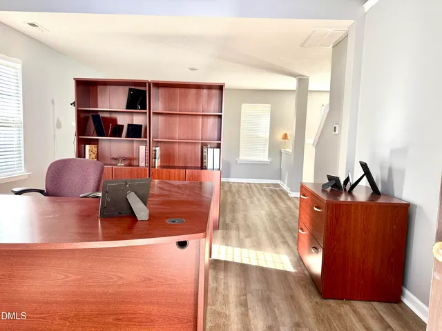 a living room with furniture a rug and a large window