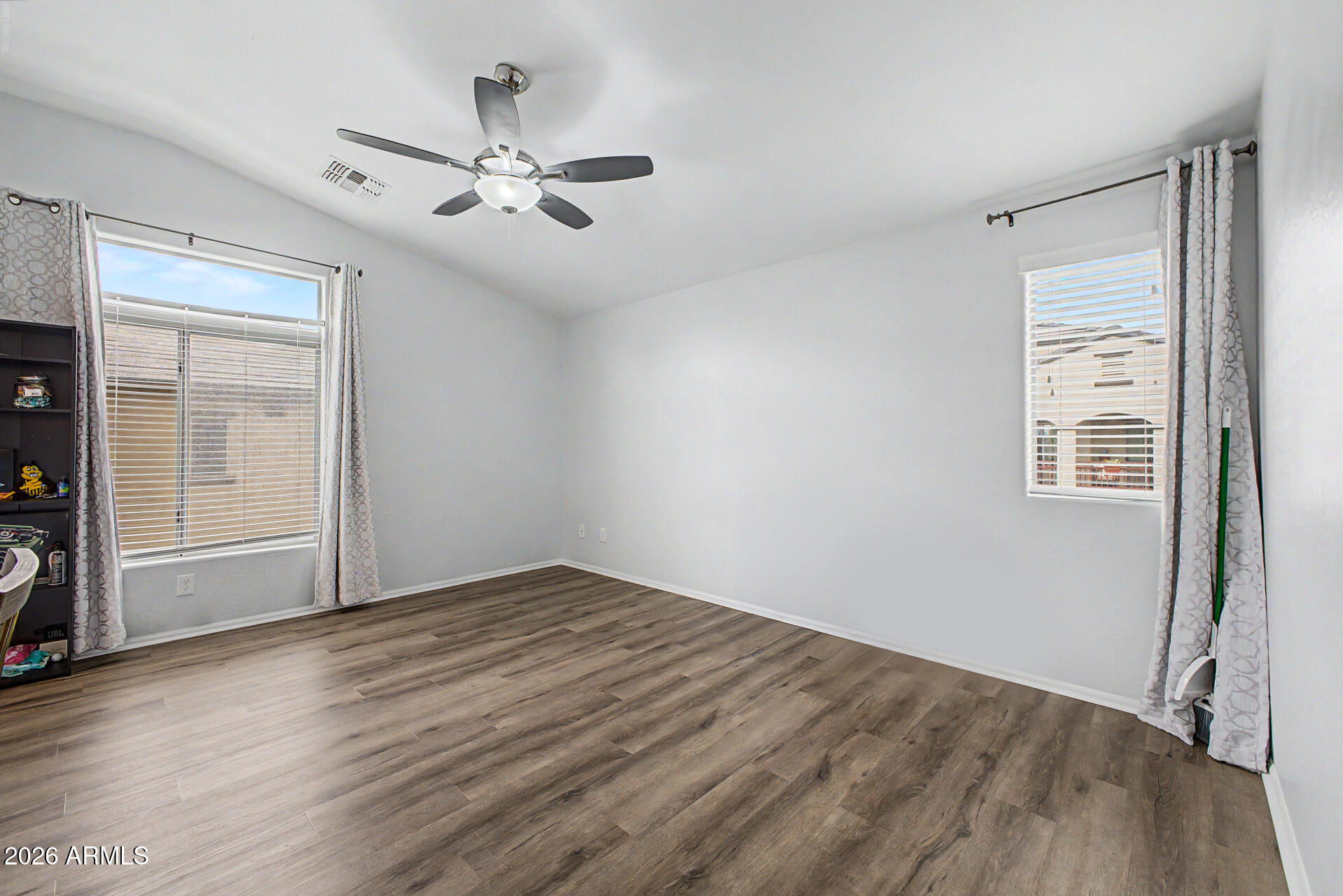 2725 East Mine Creek Road, Unit 1187 Phoenix, AZ 85024 - Photo 14 of 37 an empty room with wooden floor closet and windows