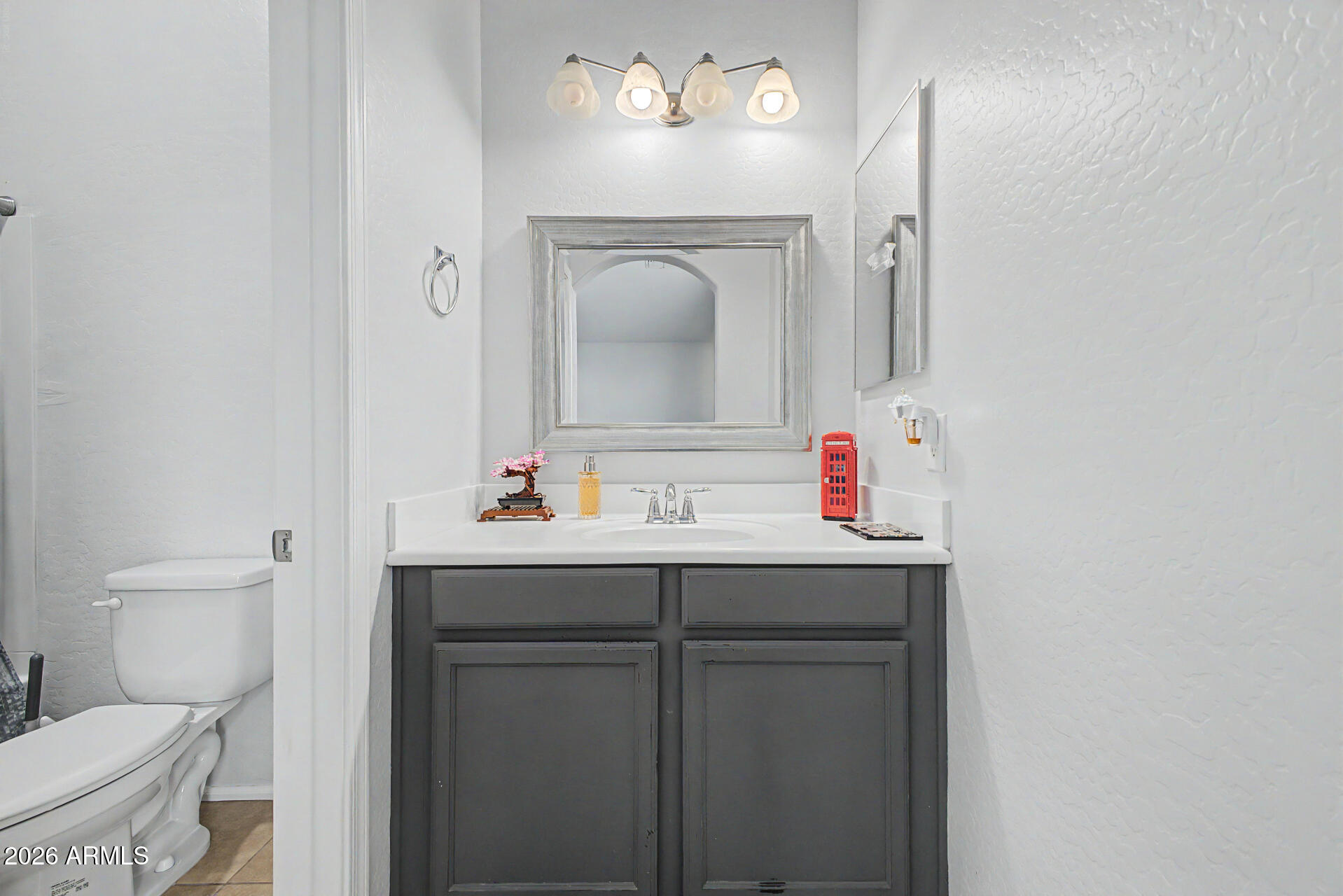 2725 East Mine Creek Road, Unit 1187 Phoenix, AZ 85024 - Photo 17 of 37 a bathroom with a sink vanity mirror and toilet